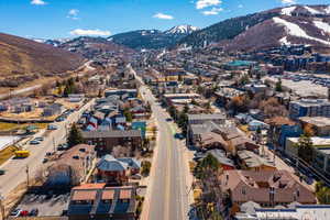 Aerial view of property and surrounding area featuring a mountainous background