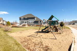 View of jungle gym with a yard