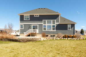 Rear view of house with a lawn