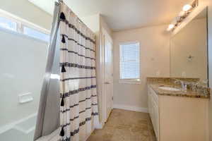 Bathroom with vanity and shower / tub combo