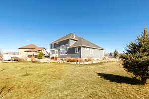 Rear view of property featuring a lawn