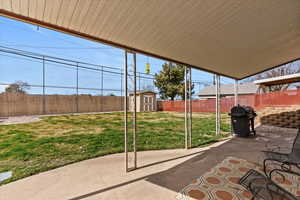Fenced backyard with a covered patio patio