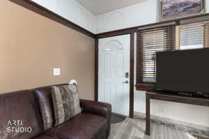 Living room with a textured ceiling and light wood-style flooring