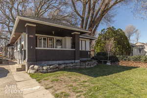 View of front of house with a front lawn and covered porch