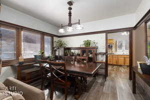 Dining space featuring dark wood-type flooring and a textured ceiling
