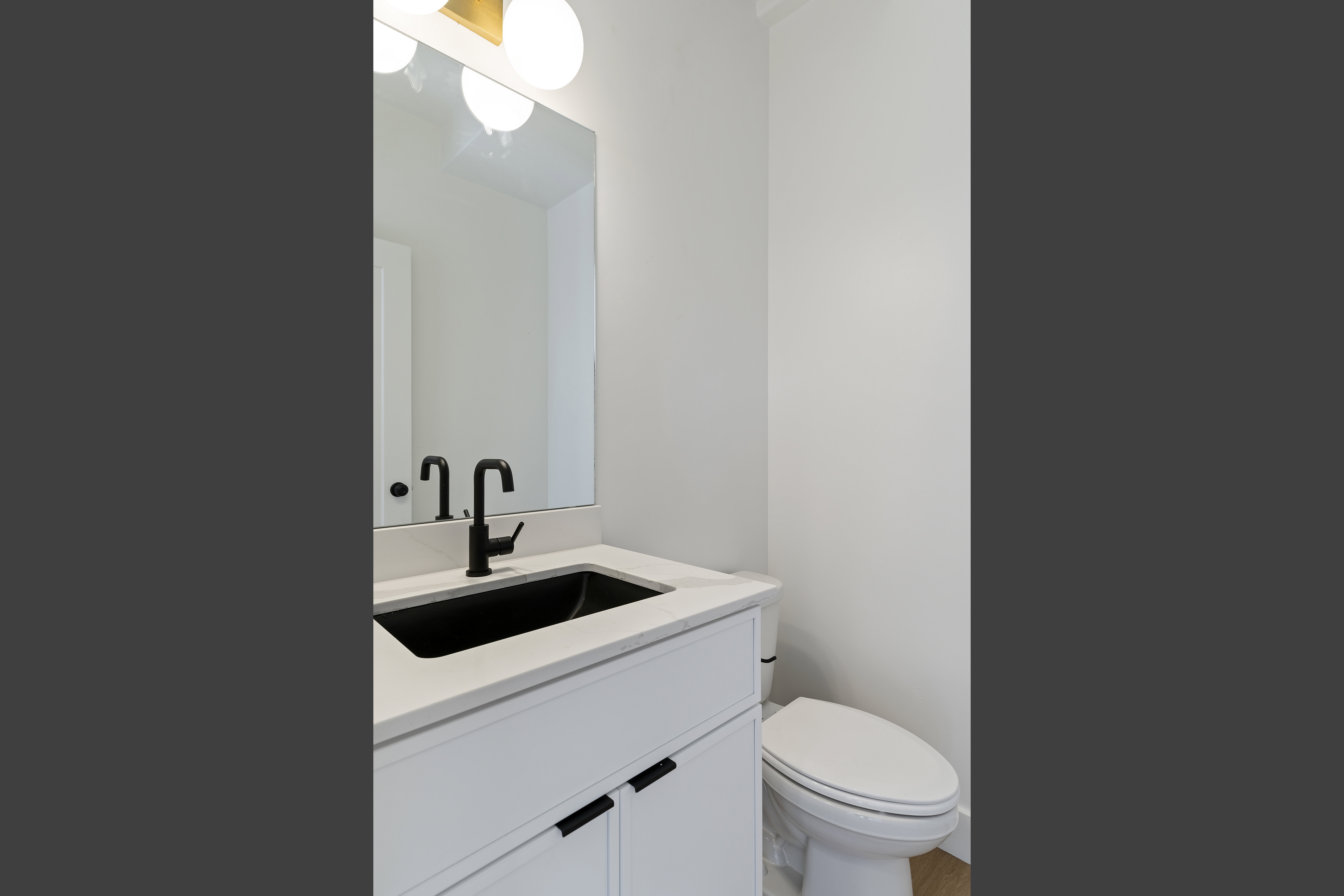 Half bath featuring vanity and toilet