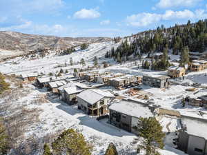 Snowy aerial view with a residential view and a mountain view