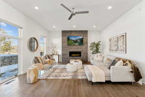 Living room featuring a ceiling fan, a tile fireplace, wood finished floors, and recessed lighting
