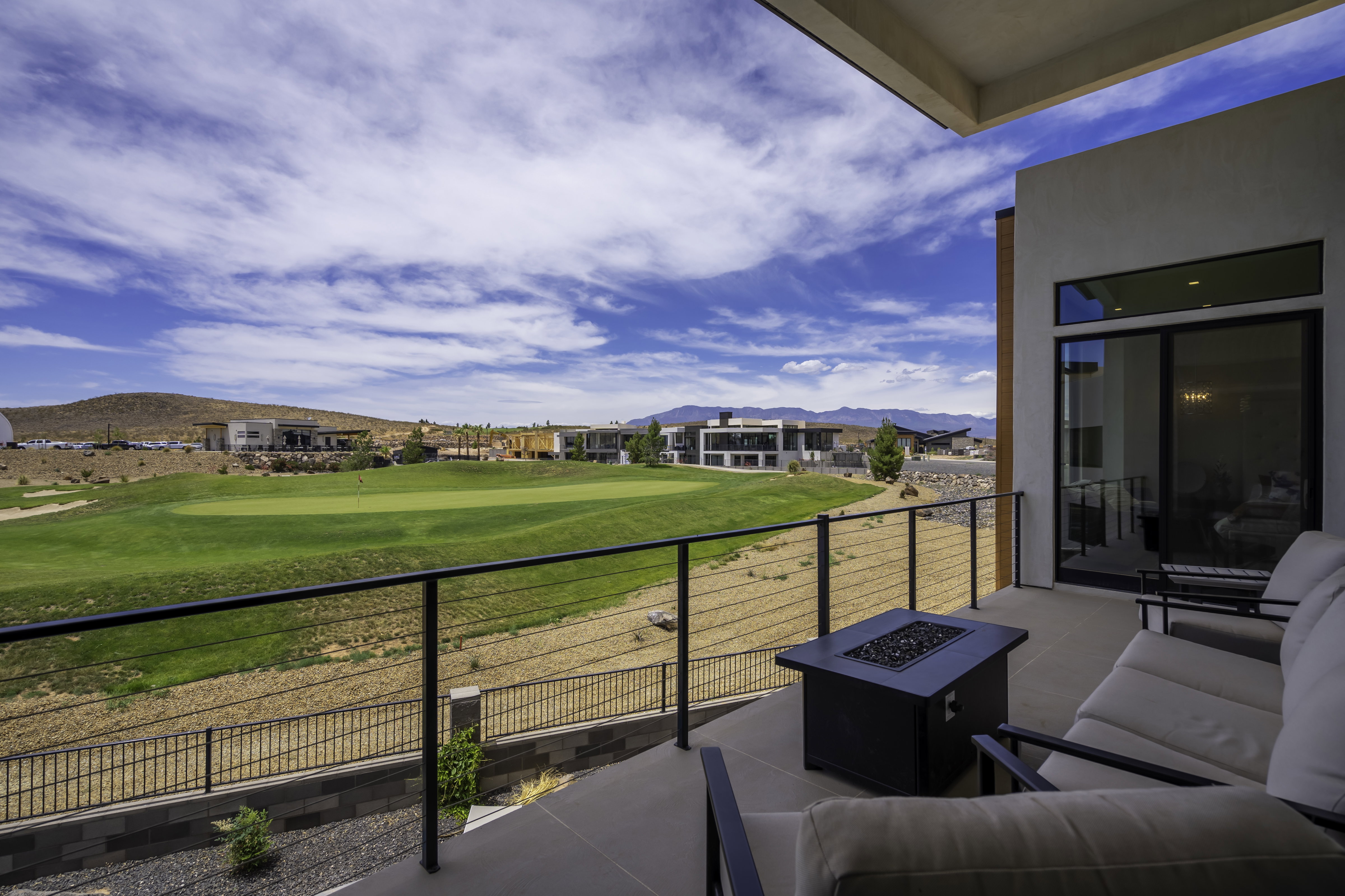 Balcony with a fire pit, a mountain view, and golf course view