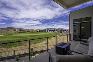 Balcony with a fire pit, a mountain view, and golf course view