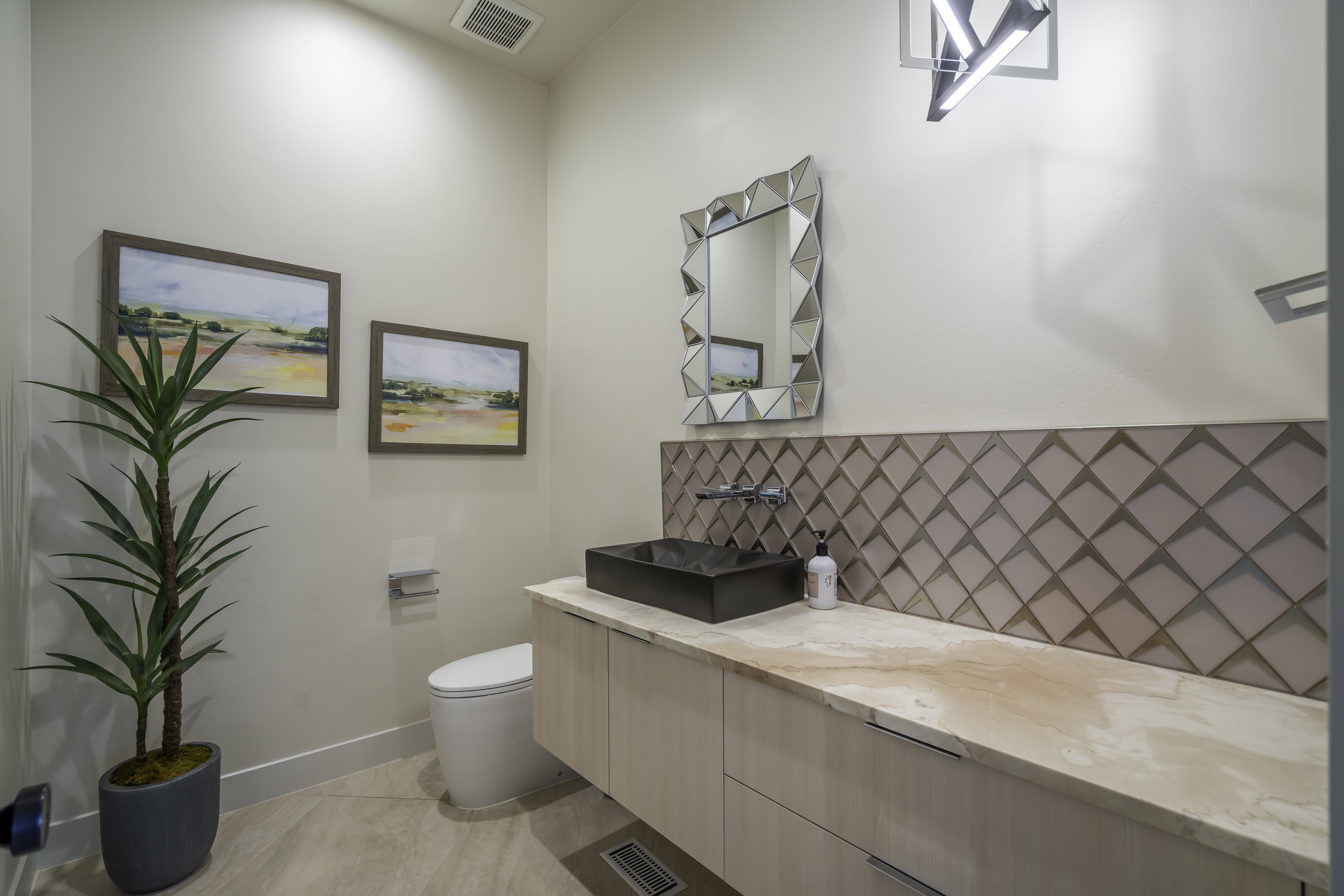 Bathroom with vanity and tasteful backsplash