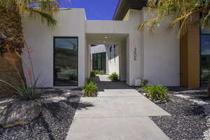 Doorway to property with stucco siding