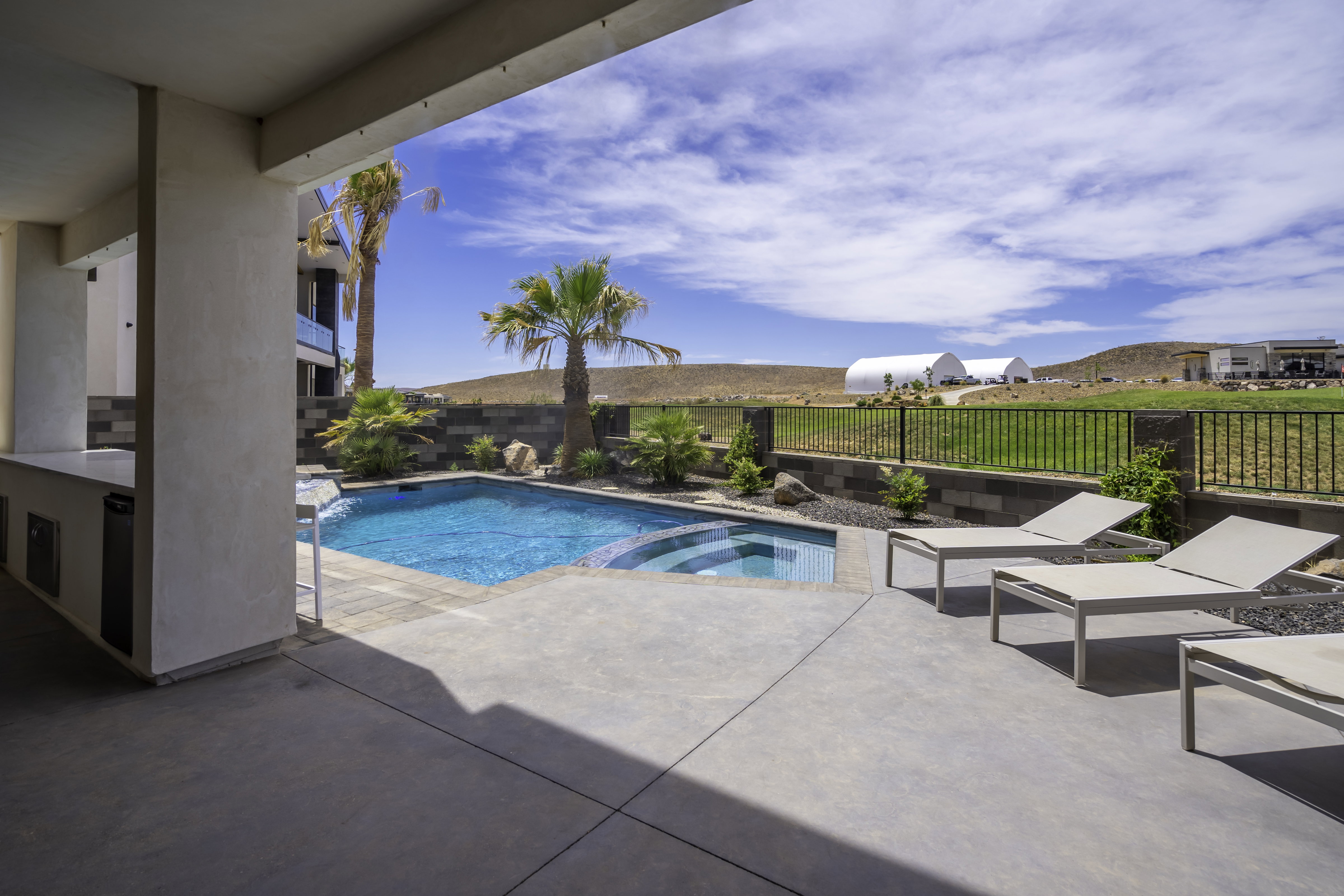 Integrated pool / spa featuring a patio area and a fenced backyard