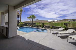 Integrated pool / spa featuring a patio area and a fenced backyard
