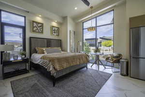 Bedroom with freestanding refrigerator, light marble finish floors, access to exterior, and ceiling fan