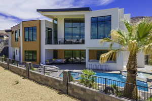 Back of property featuring a patio area, outdoor lounge area, and stucco siding