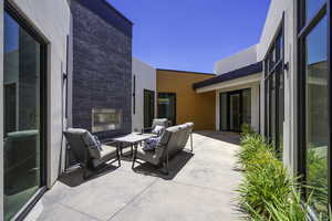 View of patio featuring an outdoor living space with a fireplace