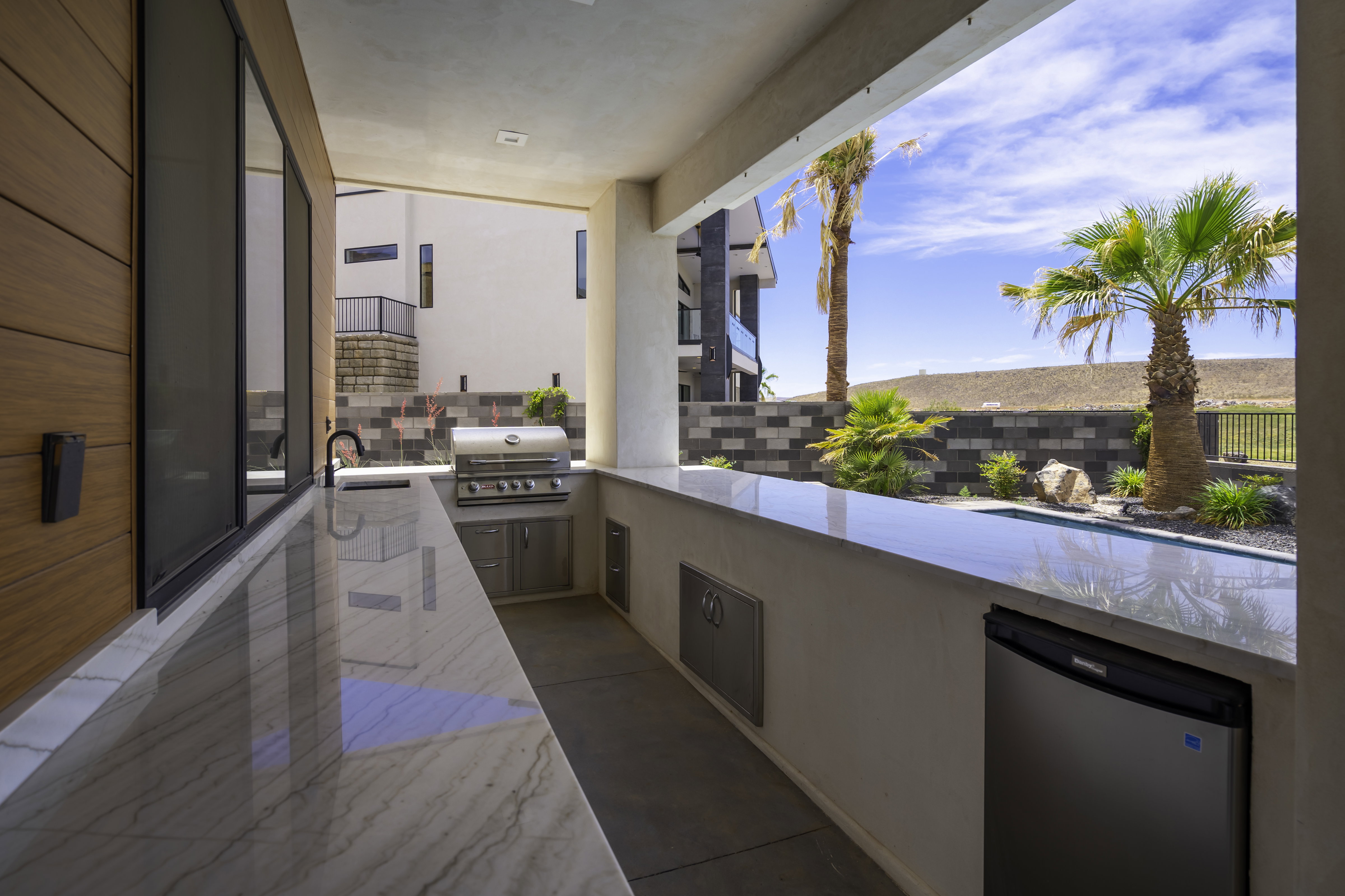 View of patio with area for grilling and a sink