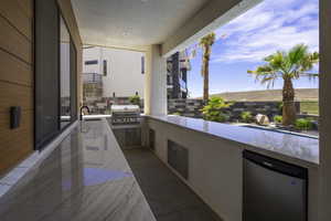 View of patio with area for grilling and a sink