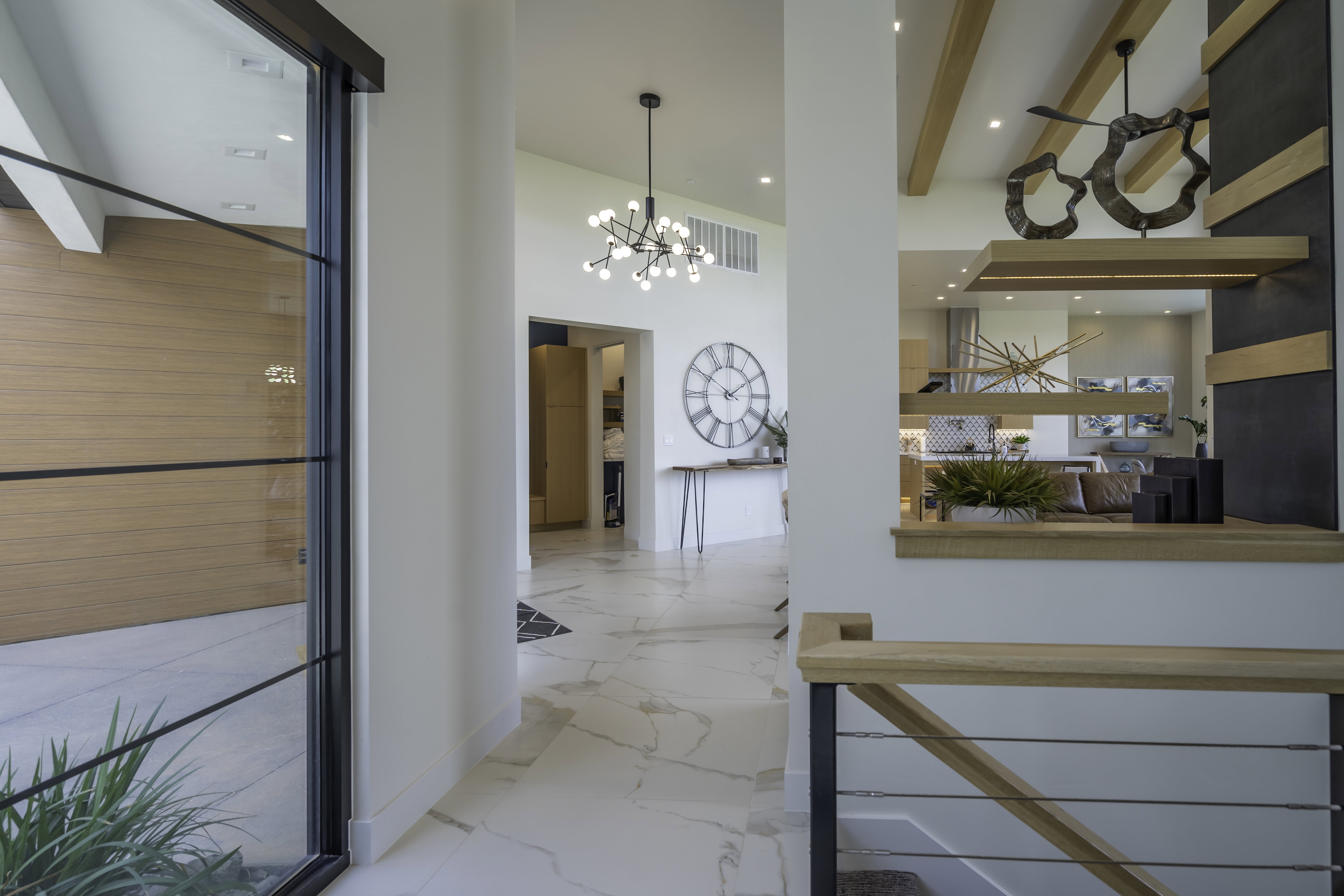 Hall with a chandelier and baseboards