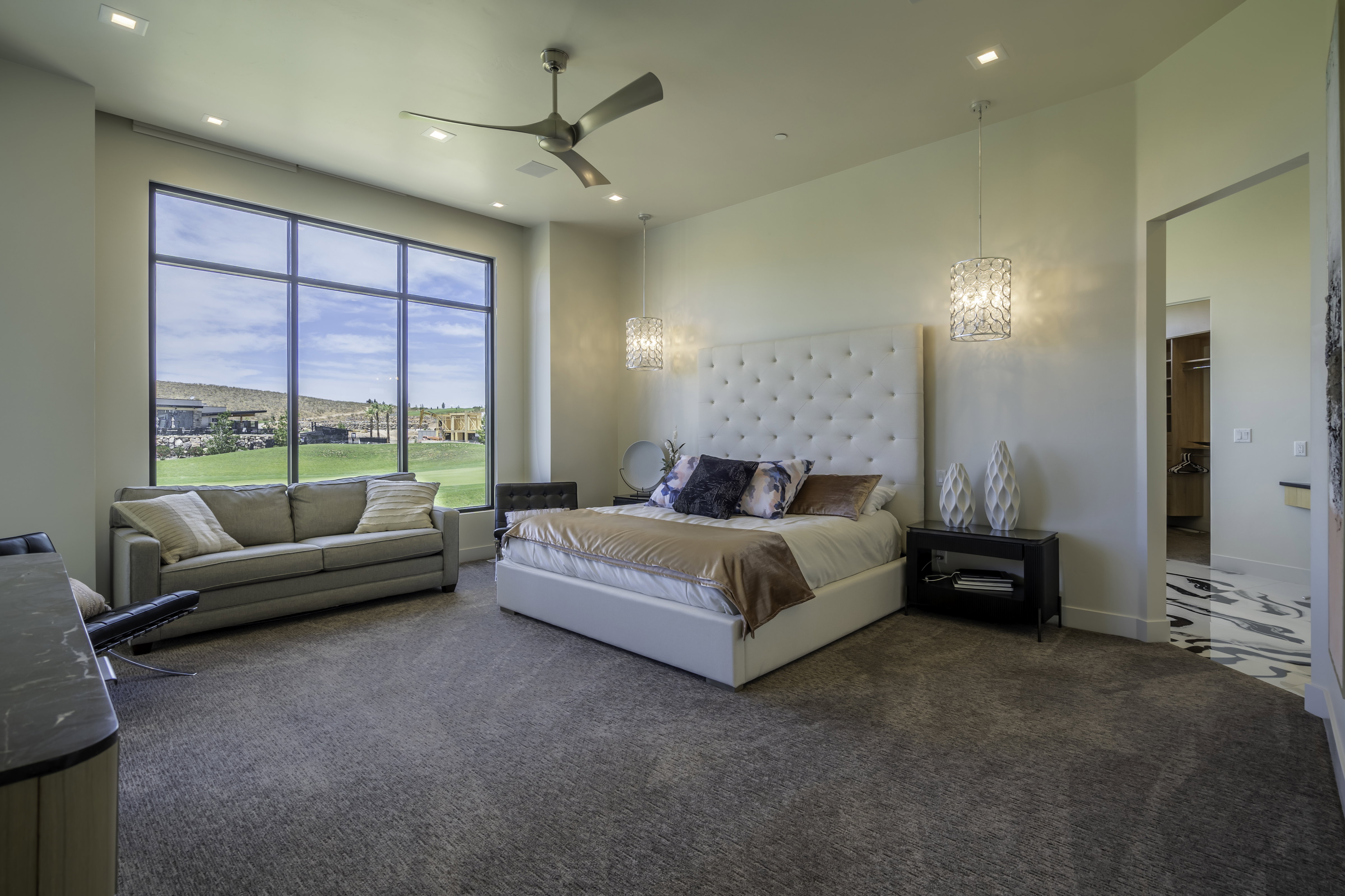 Bedroom with carpet flooring, ceiling fan, and hanging lights