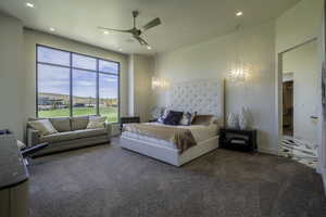 Bedroom with carpet flooring, ceiling fan, and hanging lights