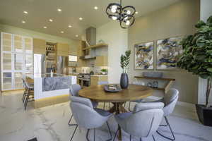 Dining room with hanging lights and light marble finish flooring