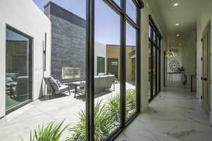 Entryway featuring a chandelier and a glass covered fireplace