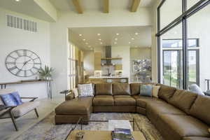 Living room featuring recessed lighting, plenty of natural light, and light marble finish flooring