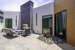View of patio / terrace featuring an outdoor living space with a fireplace