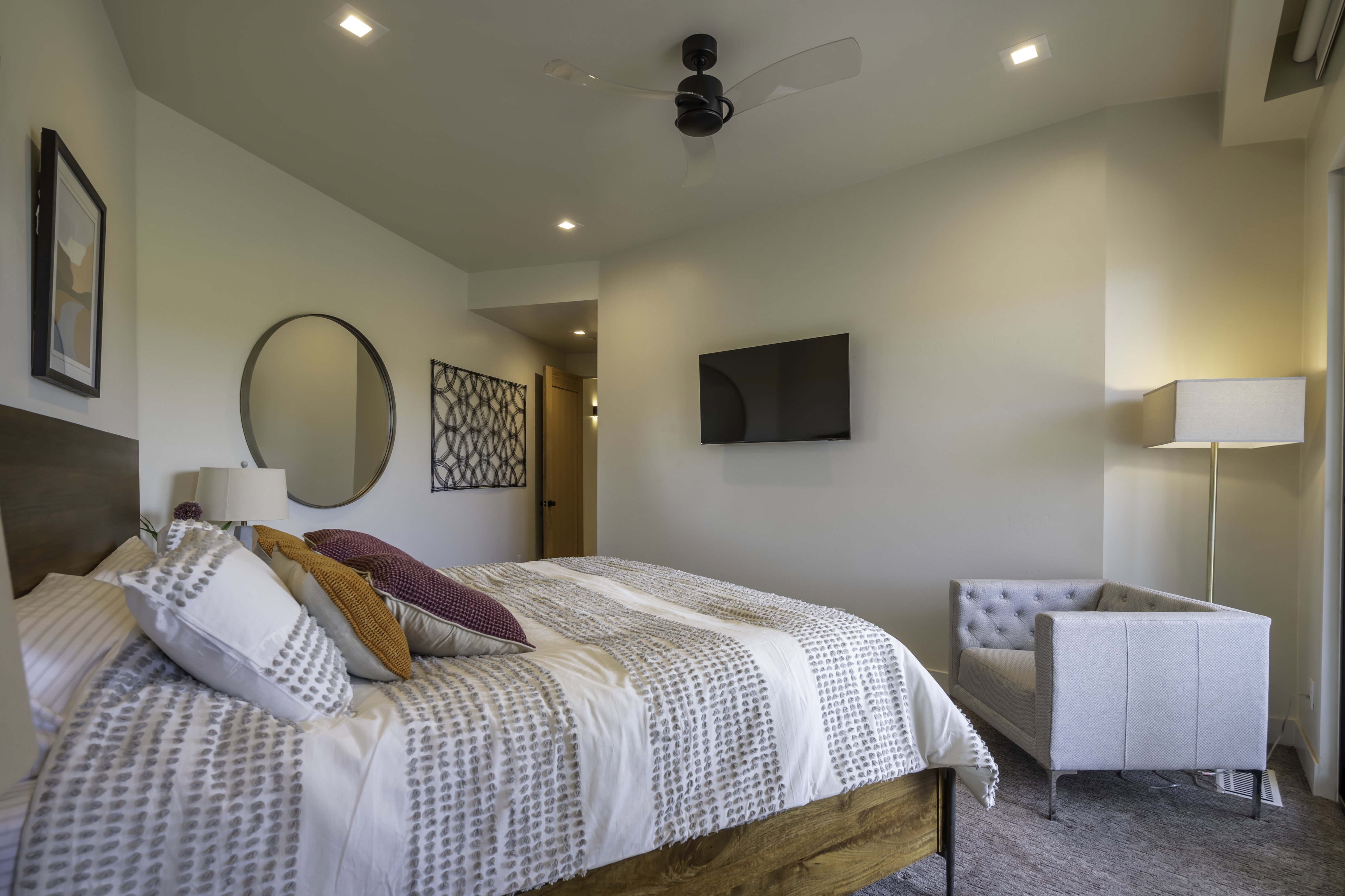 Carpeted bedroom featuring a ceiling fan and recessed lighting