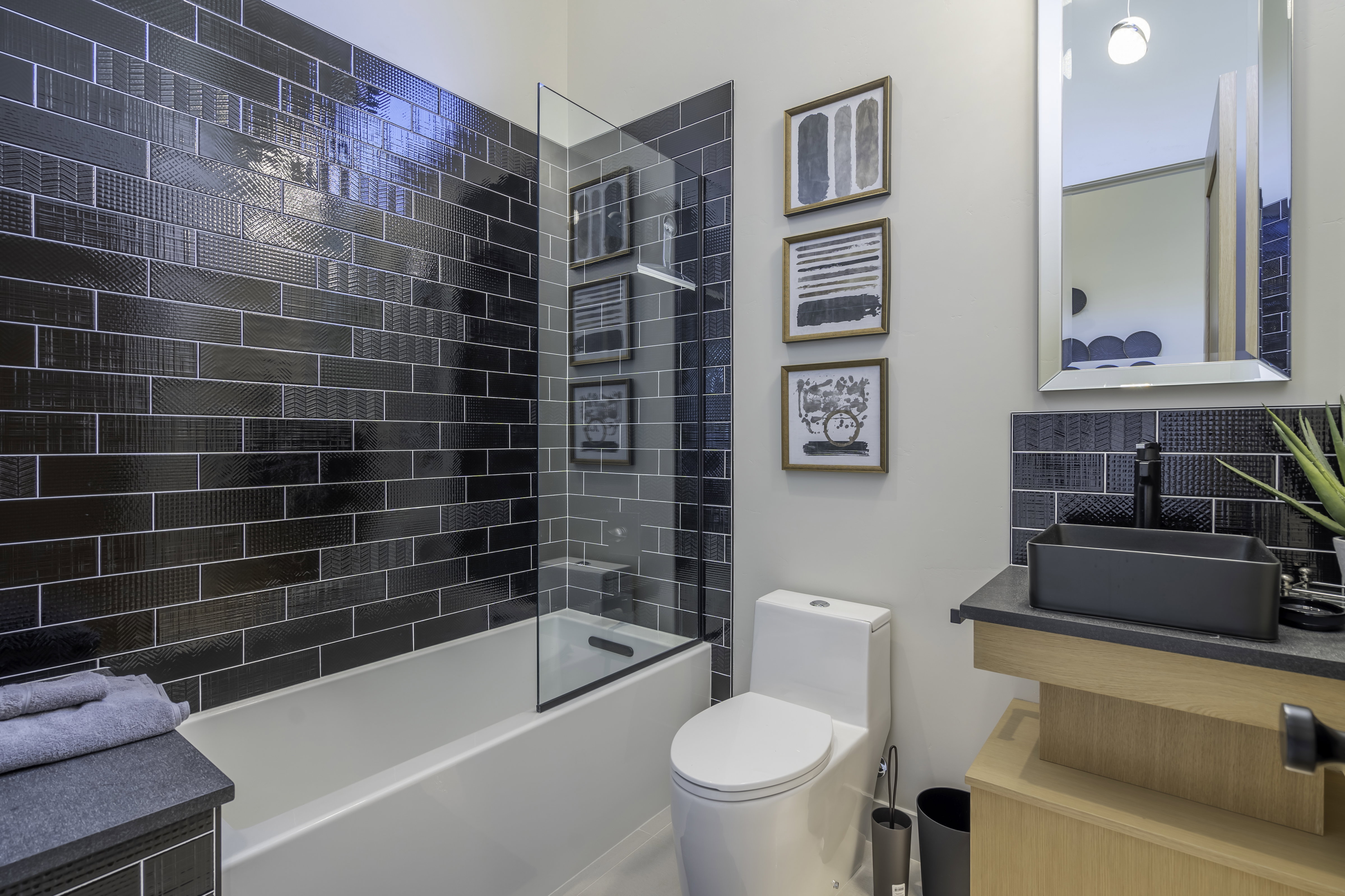 Bathroom featuring vanity, tasteful backsplash, and shower / tub combination