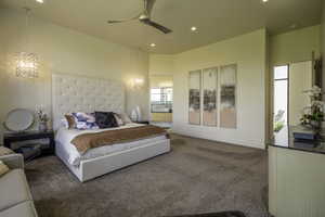 Bedroom featuring dark colored carpet, ceiling fan, recessed lighting, a high ceiling, and ensuite bath