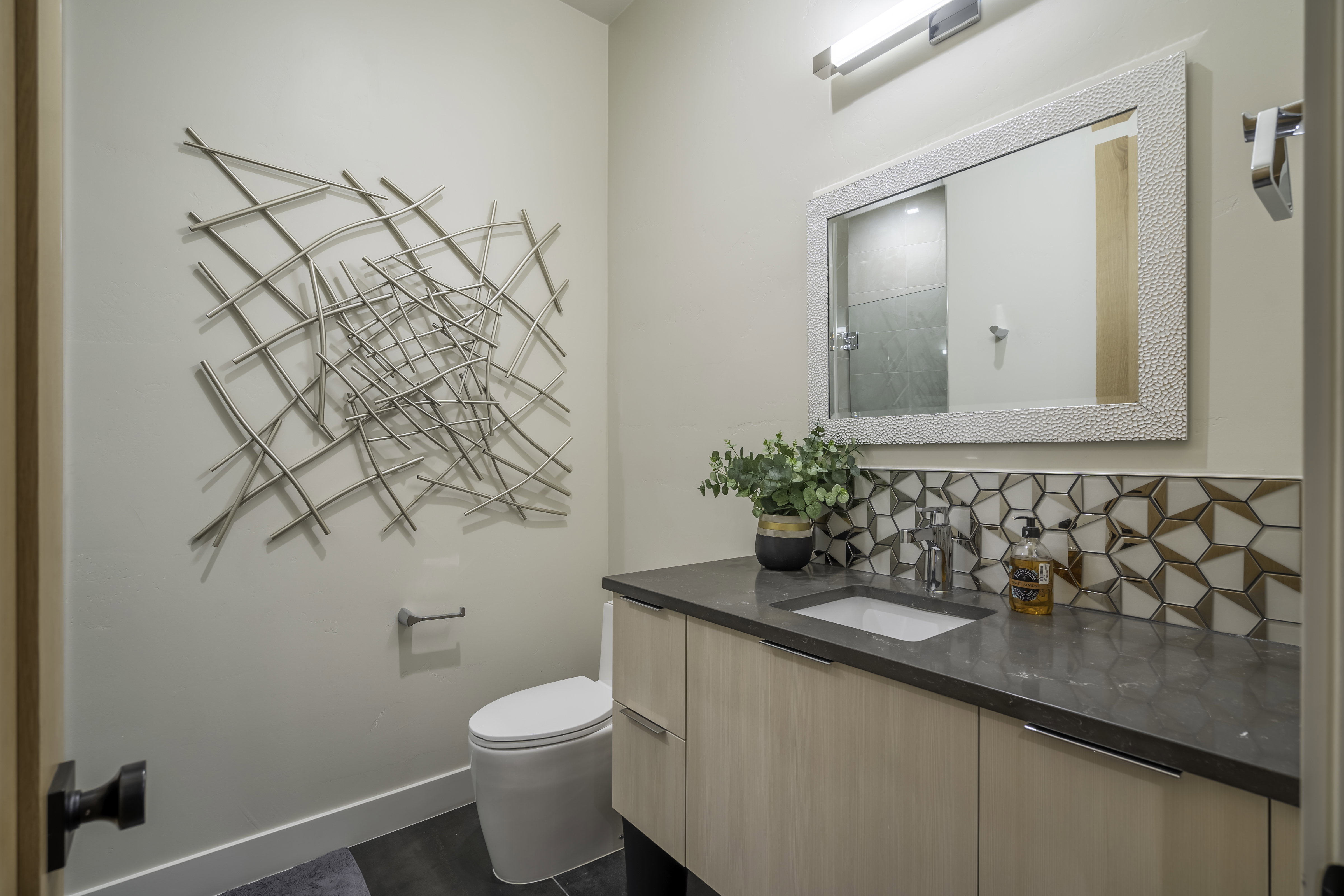 Full bath featuring vanity, tasteful backsplash, and a shower