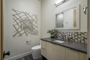 Full bath featuring vanity, tasteful backsplash, and a shower