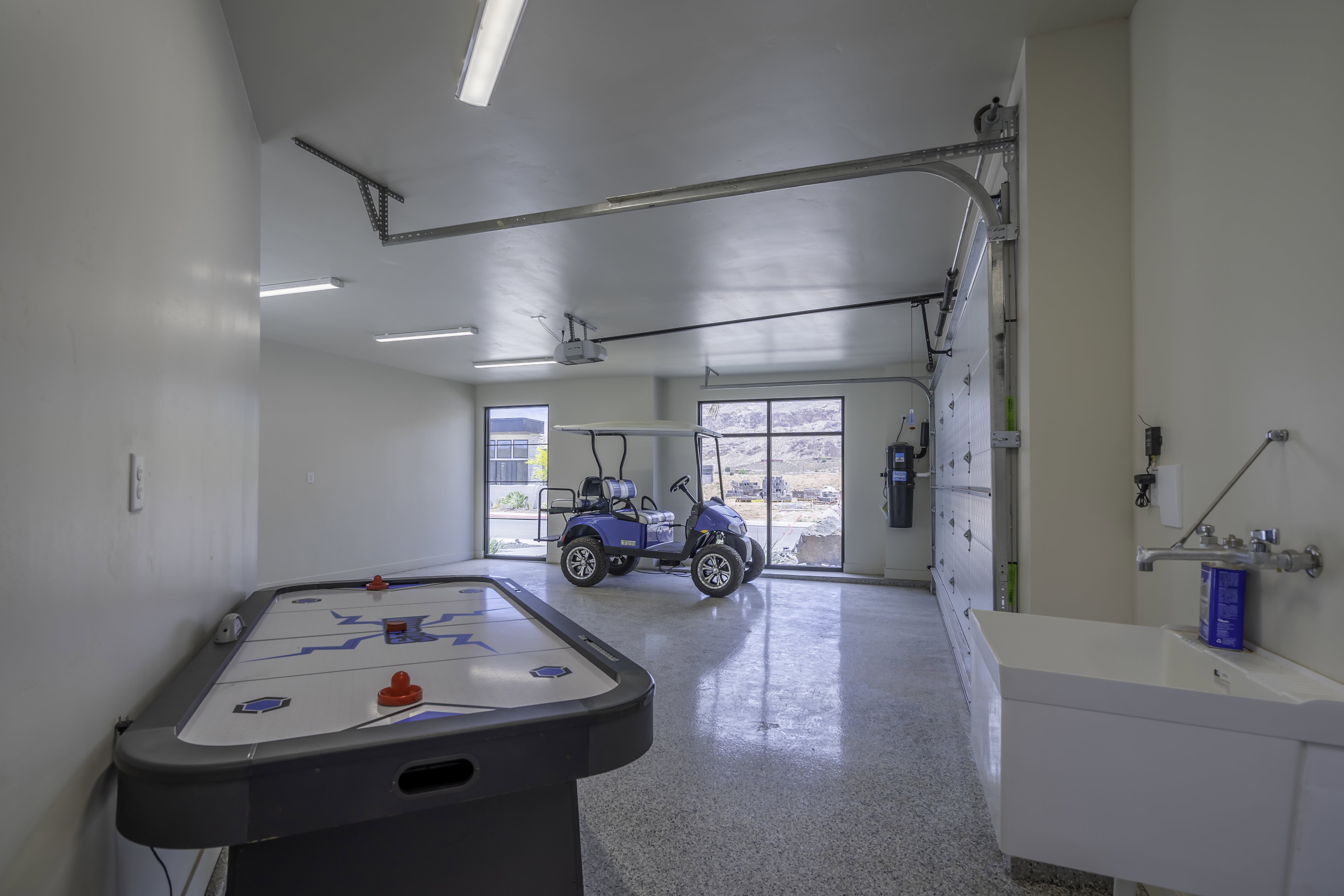 Game room with speckle patterned floor and a garage