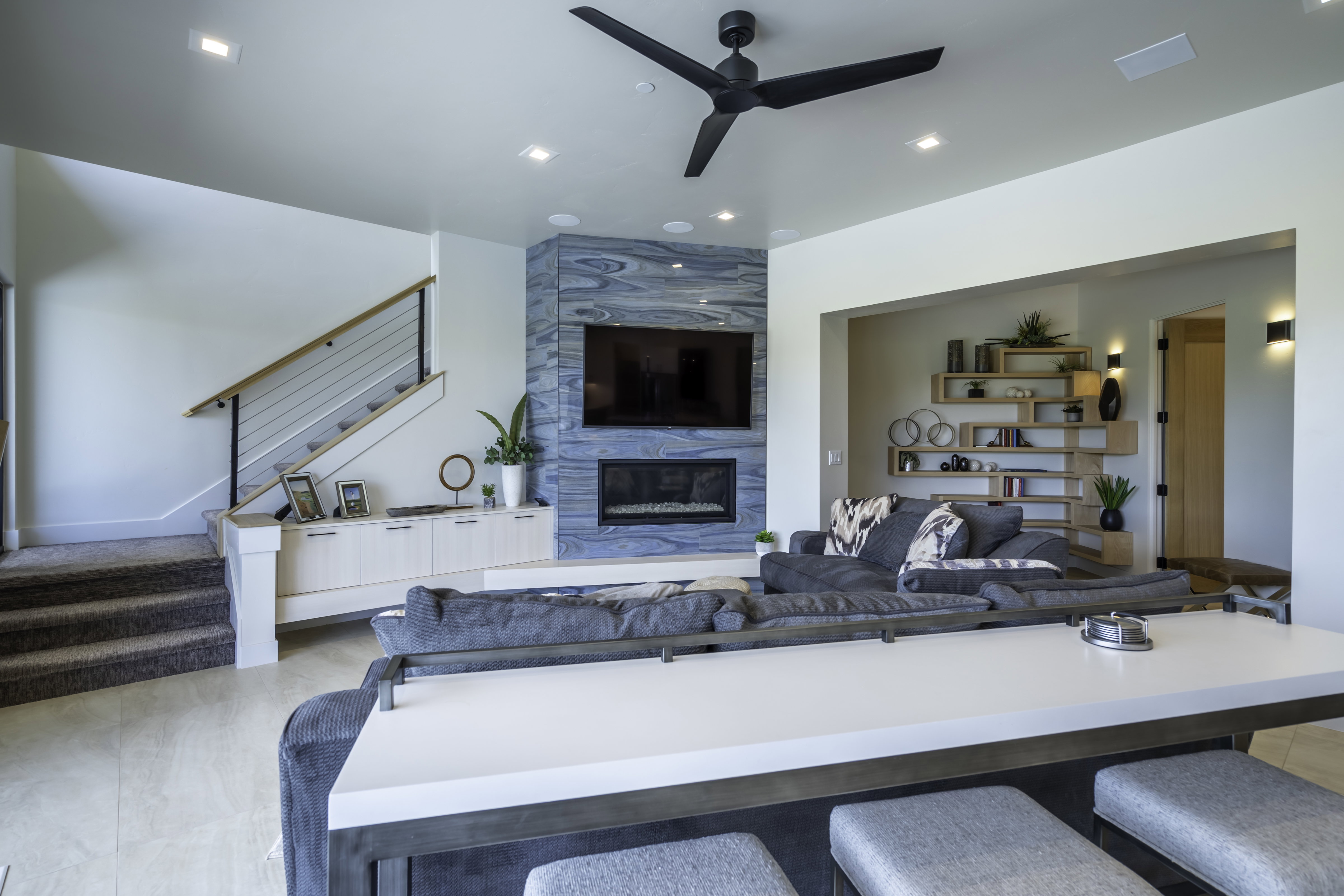 Living area featuring ceiling fan, a high end fireplace, and recessed lighting