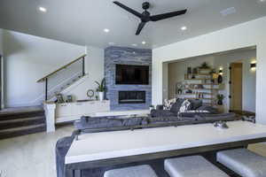 Living area featuring ceiling fan, a high end fireplace, and recessed lighting
