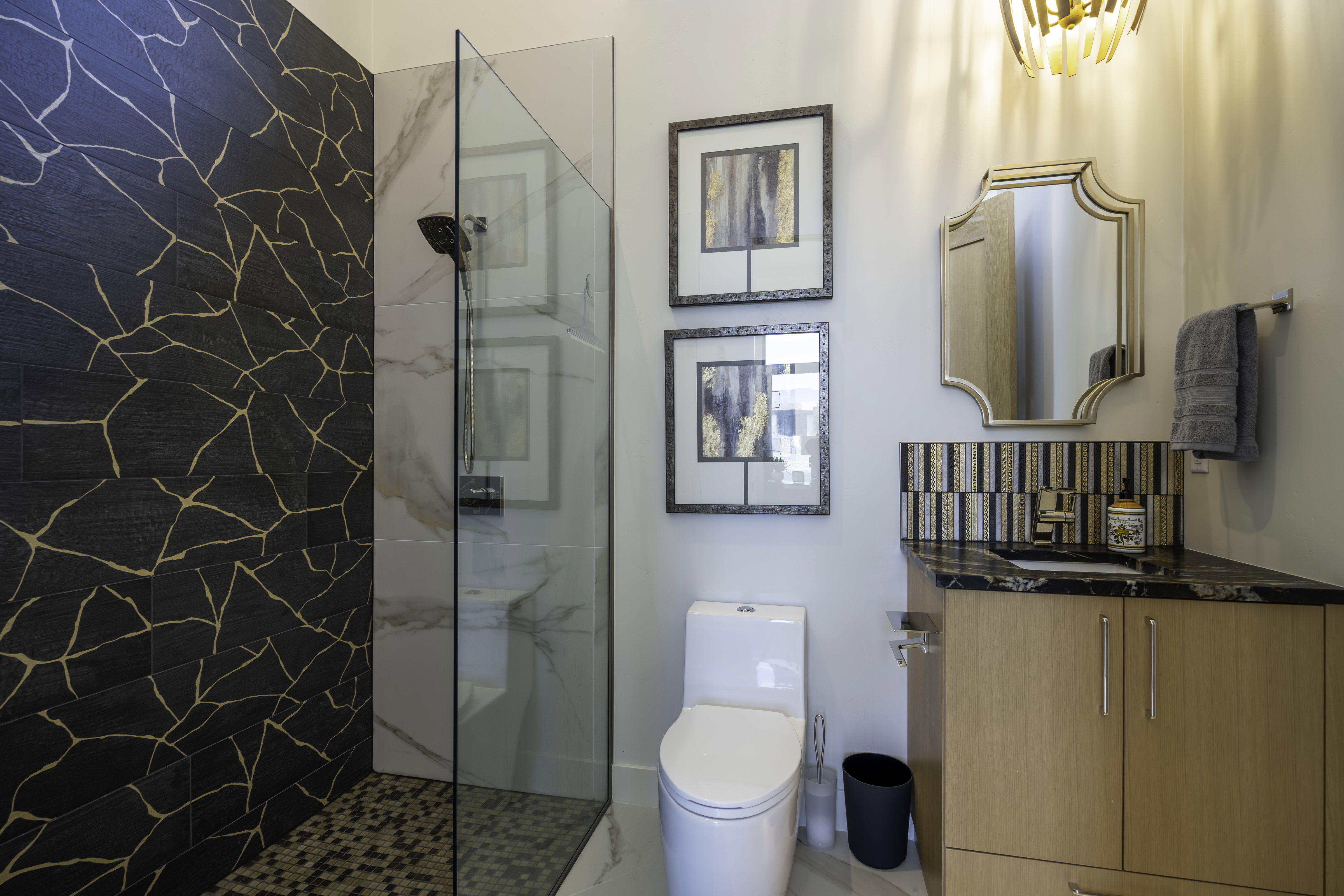 Full bathroom featuring a marble finish shower and vanity