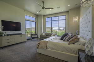 Bedroom with a ceiling fan, dark colored carpet, access to exterior, and recessed lighting