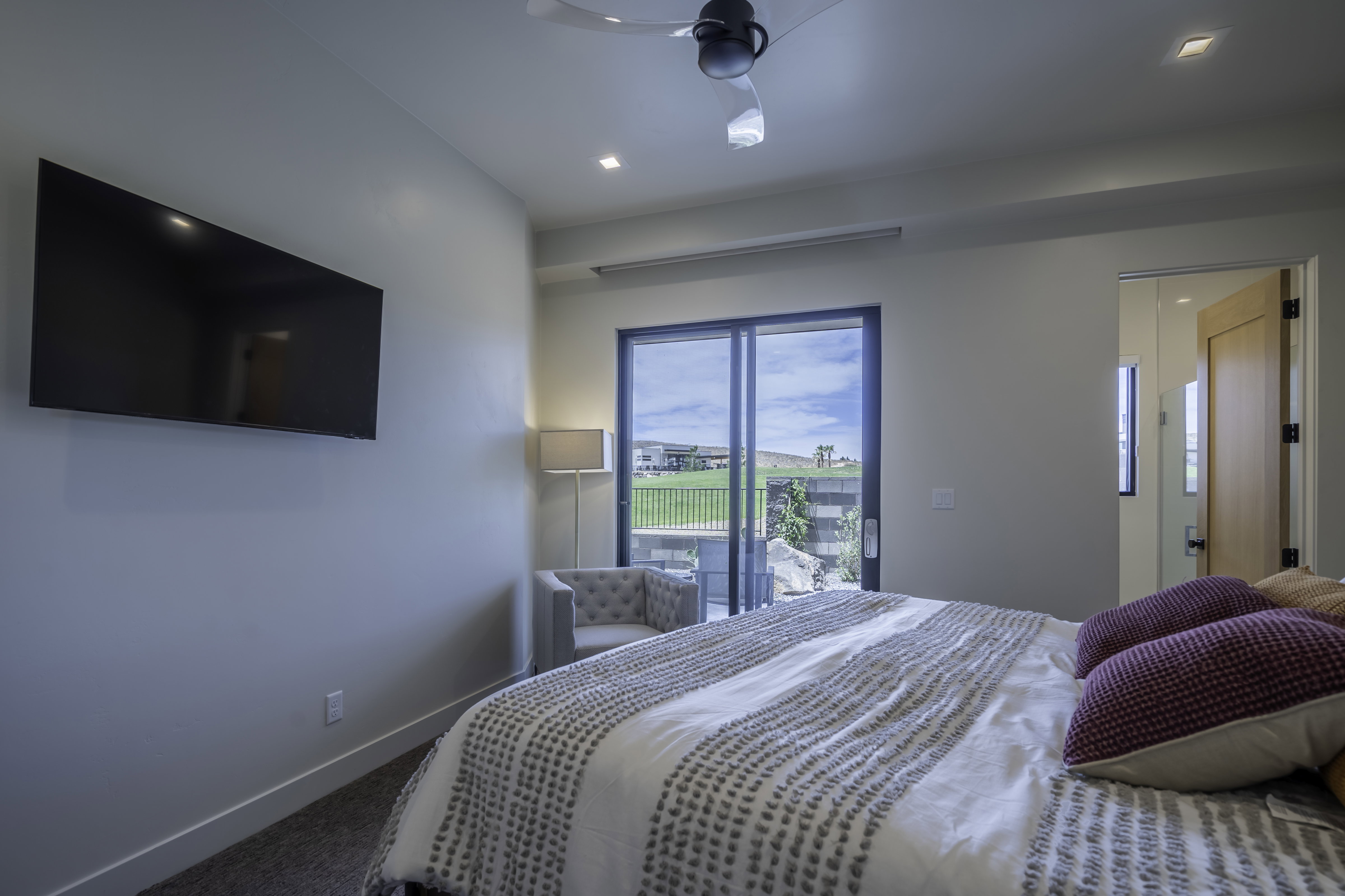 Carpeted bedroom with a ceiling fan, access to outside, and recessed lighting