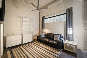 Living area with ceiling fan and a high ceiling