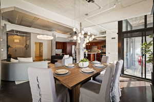 Dining room with hanging lights and dark wood finished floors