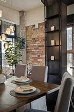 Dining room with brick wall