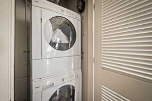 Laundry area featuring stacked washing machine and dryer