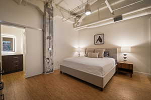 Bedroom featuring a high ceiling and baseboards