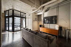 Living room featuring floor to ceiling windows and finished concrete floors