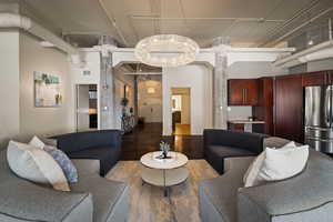 Living room featuring a high ceiling and wood finished floors