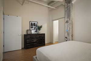 Bedroom featuring a high ceiling and baseboards