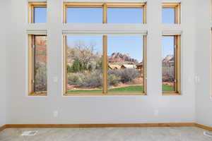 Spare room featuring a mountain view and light tile patterned floors